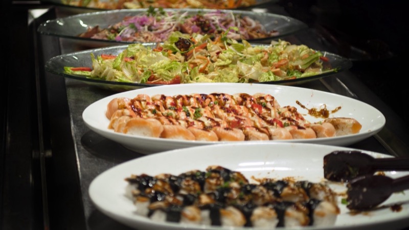 Full buffet spread showcasing food variety at Tomi